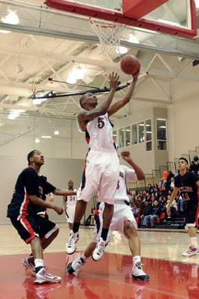 Forward Chris White (center) swoops in for a layup in the Rams' win over Skyline, Feb 19 at the Wellness Center. White was name first-team all Coast Conference this season. ROBERT ROMANO / THE GUARDSMAN