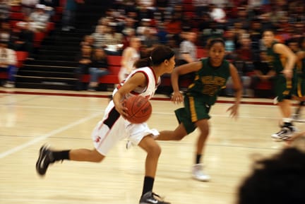 Freshman guard TC Smith leads a Rams fast break against Ohlone's Jasmine Rubin at the Wellness Center on March 6. RAMSEY EL-QARE / THE GUARDSMAN 