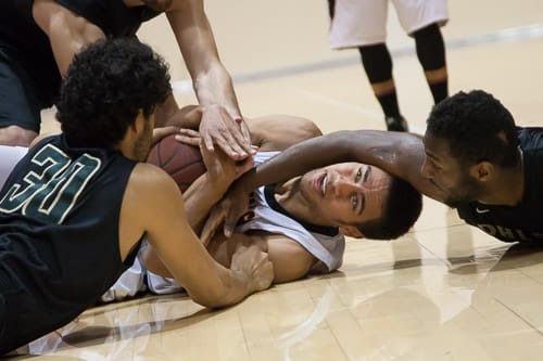 San Francisco Rams sophomore guard Joshua Fox (21) defends the ball against the Ohlone College Renegades in a CCCAA men’s basketball game on Ocean campus, Friday, Feb. 22, 2014. The Rams won the game 71-63, finishing the regular season 12-0 undefeated. They won the Coast-North Conference title and will compete in playoffs next week. Photo by Santiago Mejia/The Guardsman