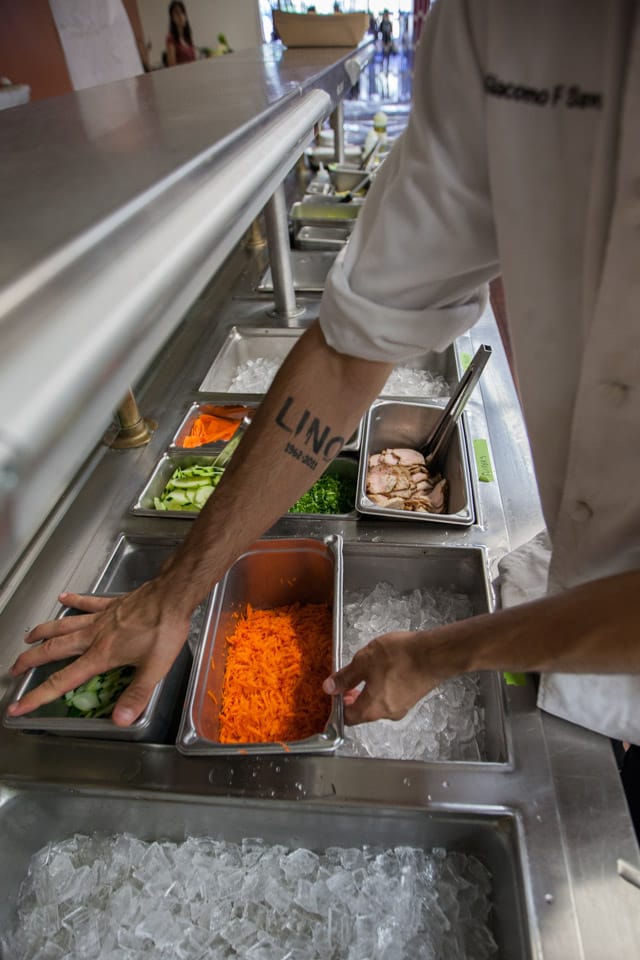 Giacomo Savoia, a third semester Culinary Arts and Hospitality Studies student, prepares the sandwich station for the grand opening of Radius 99 on Wednesday, Aug. 27, 2014 at City College’s Ocean campus. (Photo by Nathaniel Y. Downes)