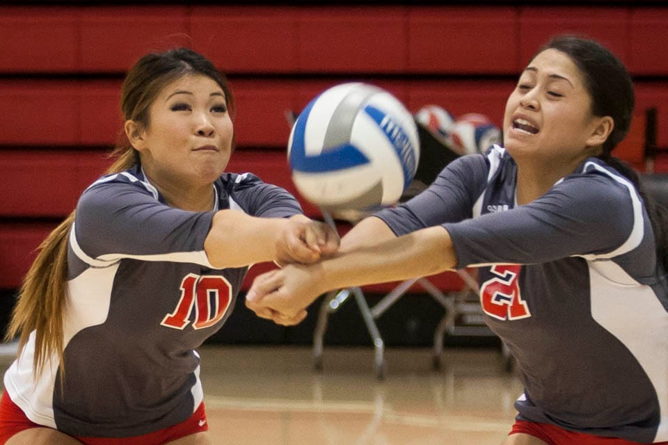 Rams Cynthia Lin (10) and Gaea Salazar (21) both dig at an incoming spike. (Photo by Santiago Mejia)