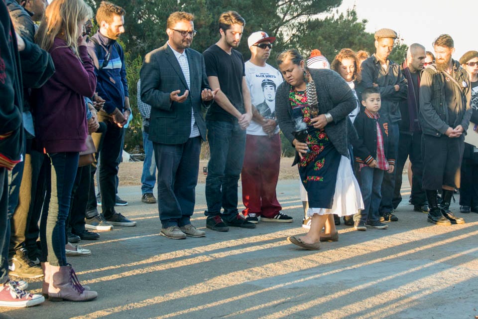 Lorena de la Rosa burns sage in an Aztec ceremony that symbolizes cleansing, purifying and protecting of the physical and spiritual bodies during the sunset vigil in honor of  Alex Nieto at the 5-month anniversary of his death in Bernal Heights Park in San Francisco on Thursday, Aug. 21, 2014. (Photo by Niko Plagakis)