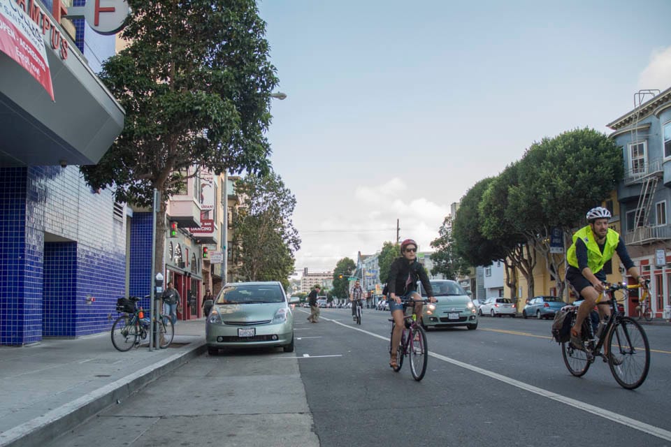 A cyclist rides past the City College Mission Center, Thursday, Sept. 25. (Photo by Niko Plagakis)