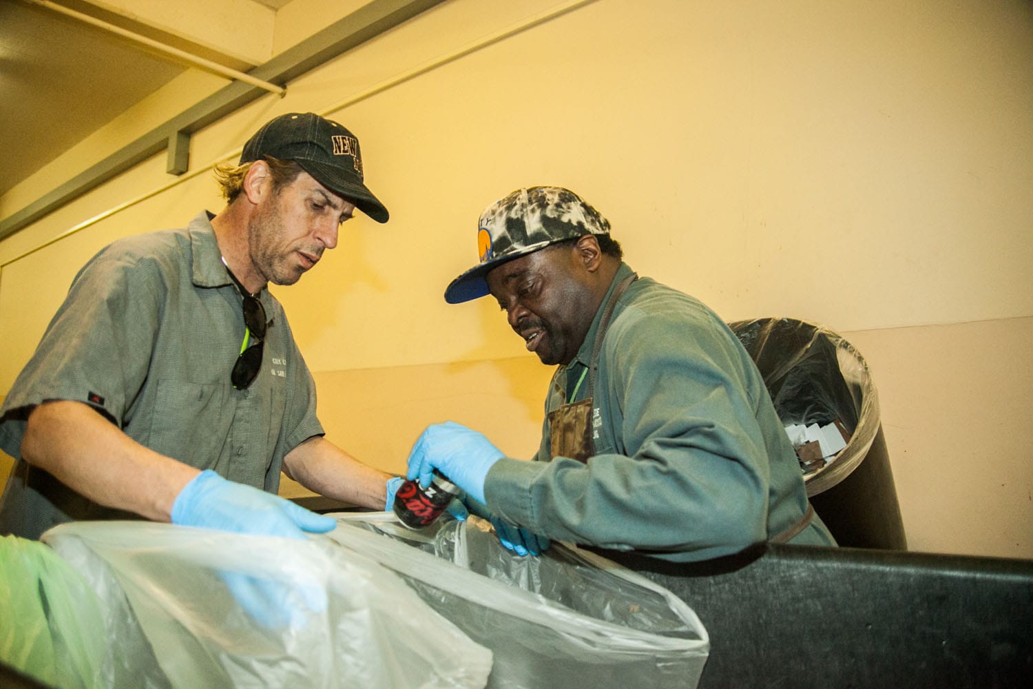 (L-R) Two City College students, work-study student Gary Wieder and classified worker Tim Harper from the Recycling Department go through every classrooms and offices in the Cloud Hall Building on Ocean Campus to pick up and sort recycling materials on Monday, March 2. (Photo by Ekevara Kitpowsong)  