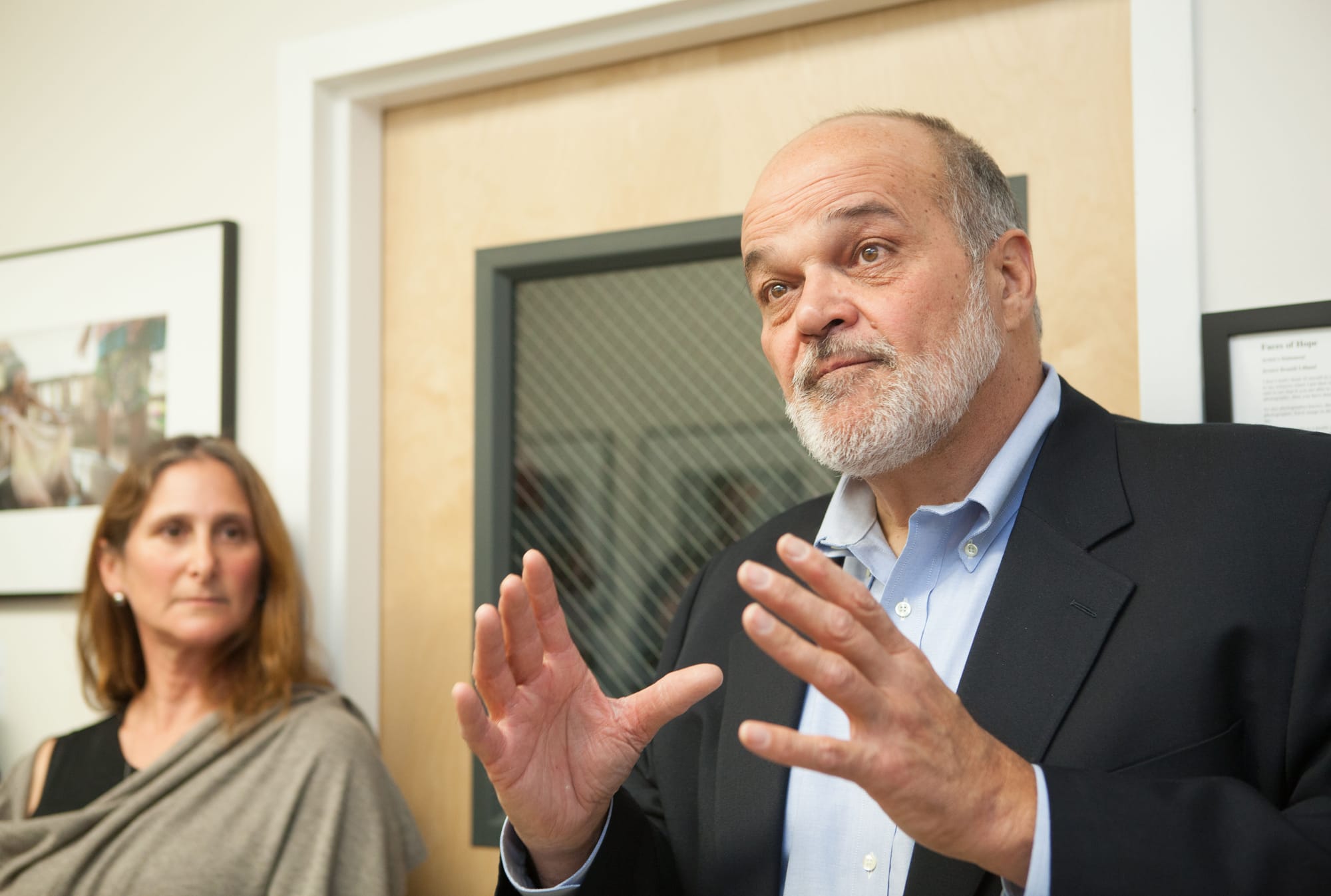 Special guest, Pulitzer Prize winning photojournalist and San Francisco State professor Kim Komenich, and the featured artist Jessica Lifland, speak to attendees including City College faculty and students during the opening reception for “Faces of Hope” at Front Page Gallery on Thursday, Sept. 17, 2015. (Photo by Ekevara Kitpowsong/The Guardsman)