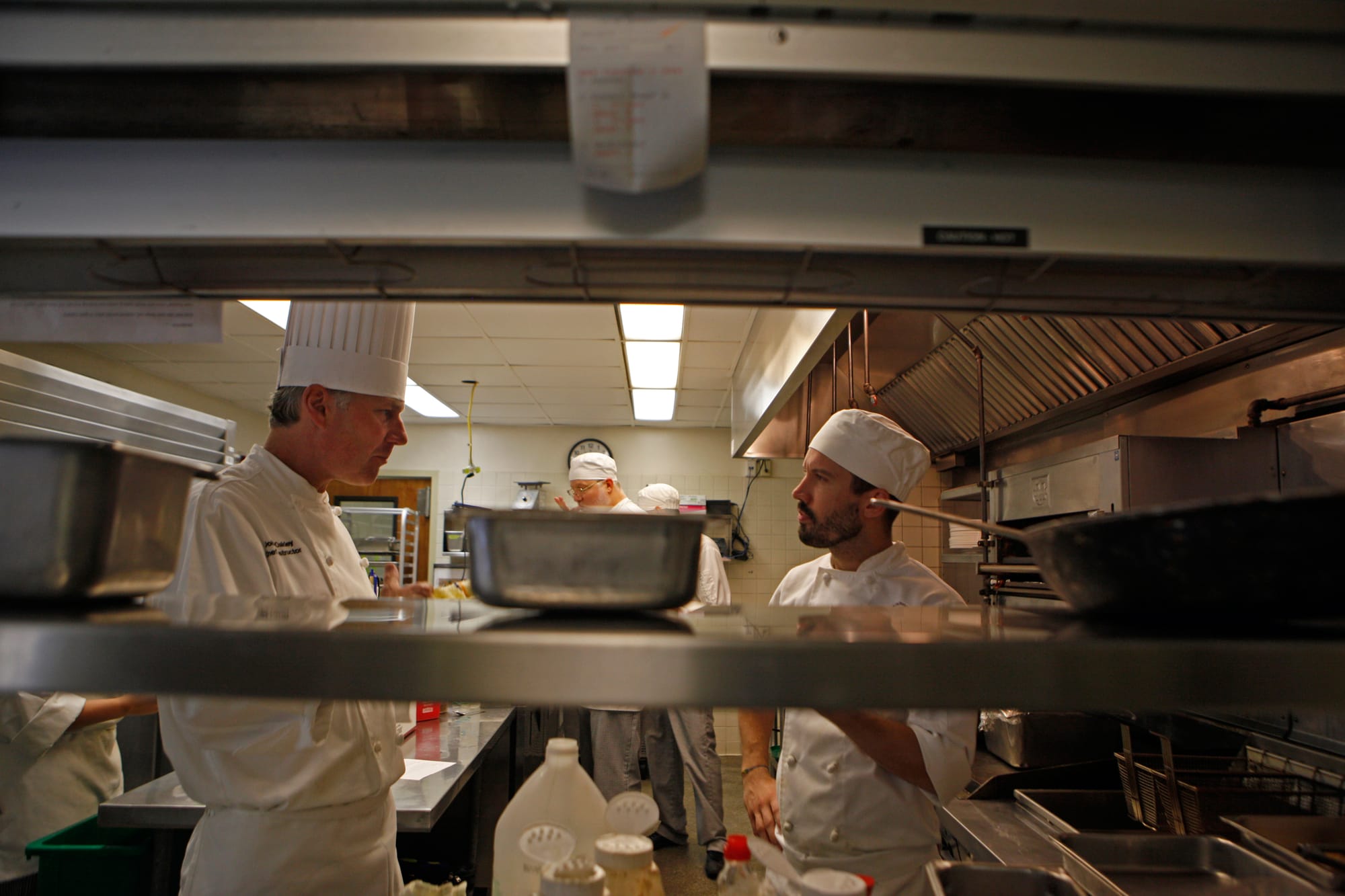 Chef John Oakley speaks with second semester student Zach Taylor during the preparation process for the Pierre Coste dining room. (Photo by Franchon Smith/ The Guardsman)