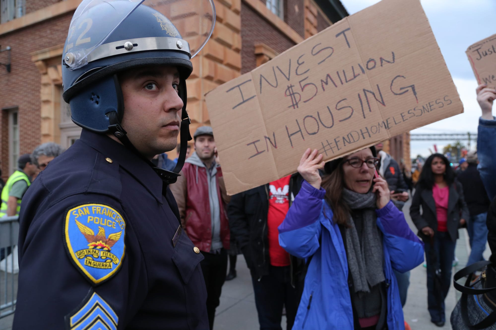 Police officers watch over protesters on Feb. 3 outside the Ferry Building.