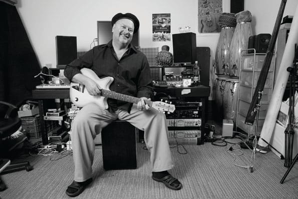 City College Instructor Greg Landau, pictured here in 2011, plays guitar in his home studio in San Francisco. (Peter Maiden/The Guardsman Archive)