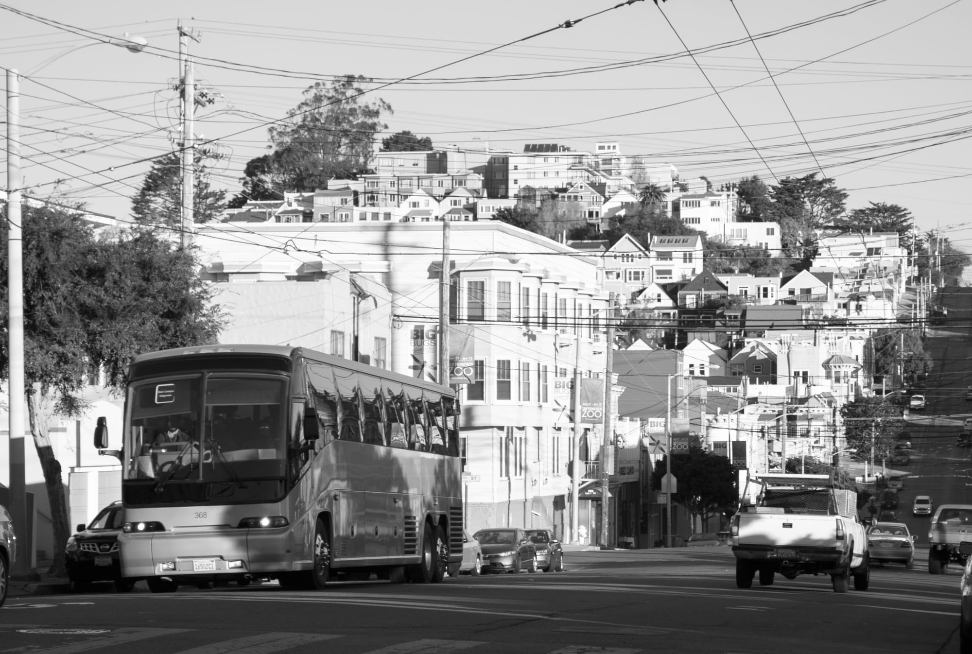 The large, unmarked "tech bus" drives through a neighborhood in San Francisco. Tech buses have become symbols of the tech invasion in the city. (Photo courtesy of Don Barret/Flickr.com)
