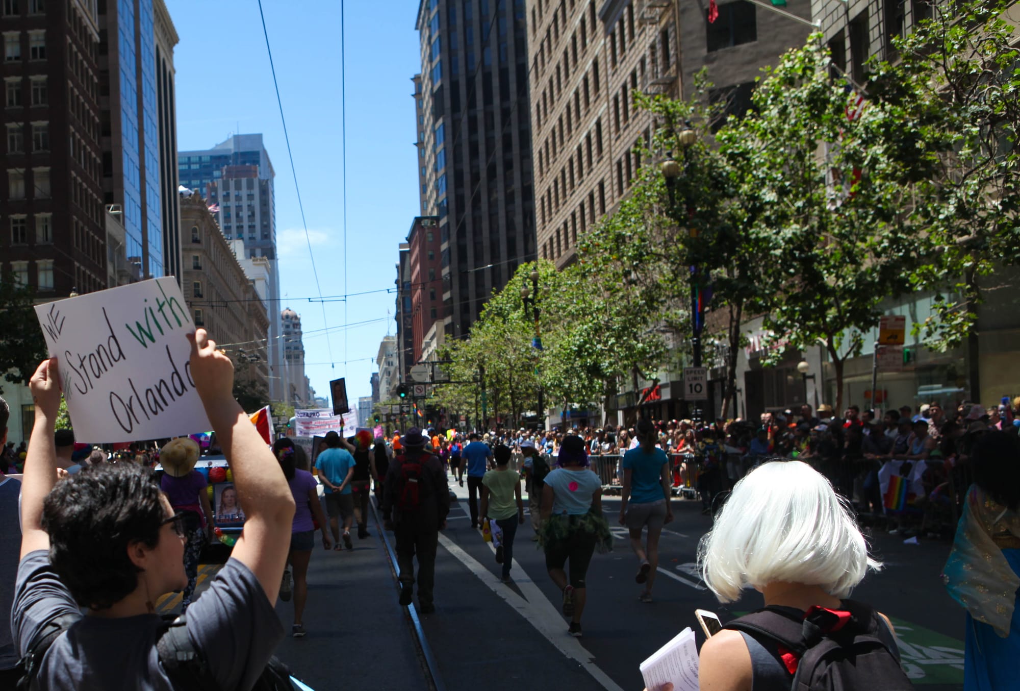 City College students walk toward the end of the San Francisco Pride Parade holding a sign that reads “We Stand With Orlando” on June 26, 2016. (Photo by Cassie Ordonio/The Guardsman)