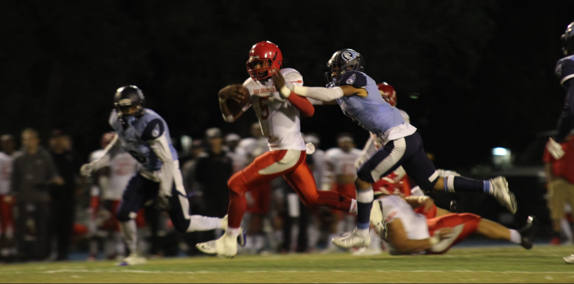 Quarterback Lavell McCullers breaks a tackle during Saturday's win against Contra Costa College (Photo by Kyle Honea/The Guardsman)