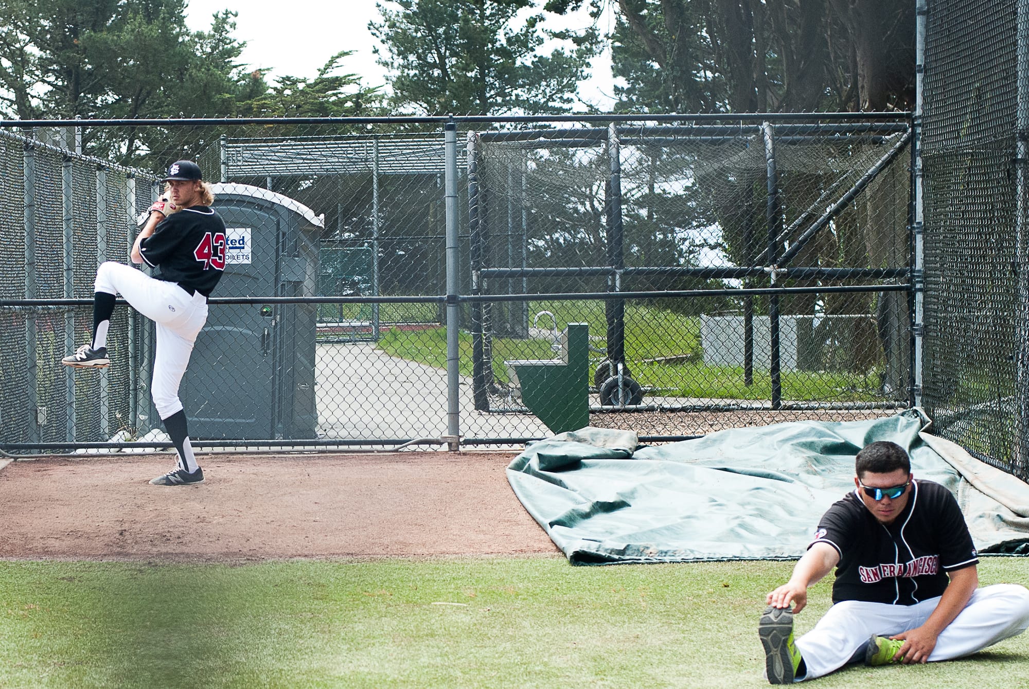 Daniel Walsh throws warmup pitches before the game agaisnt West Valley while team mate stretches.  Photo by Otto Pippenger, April 20 2017, Pacifica.