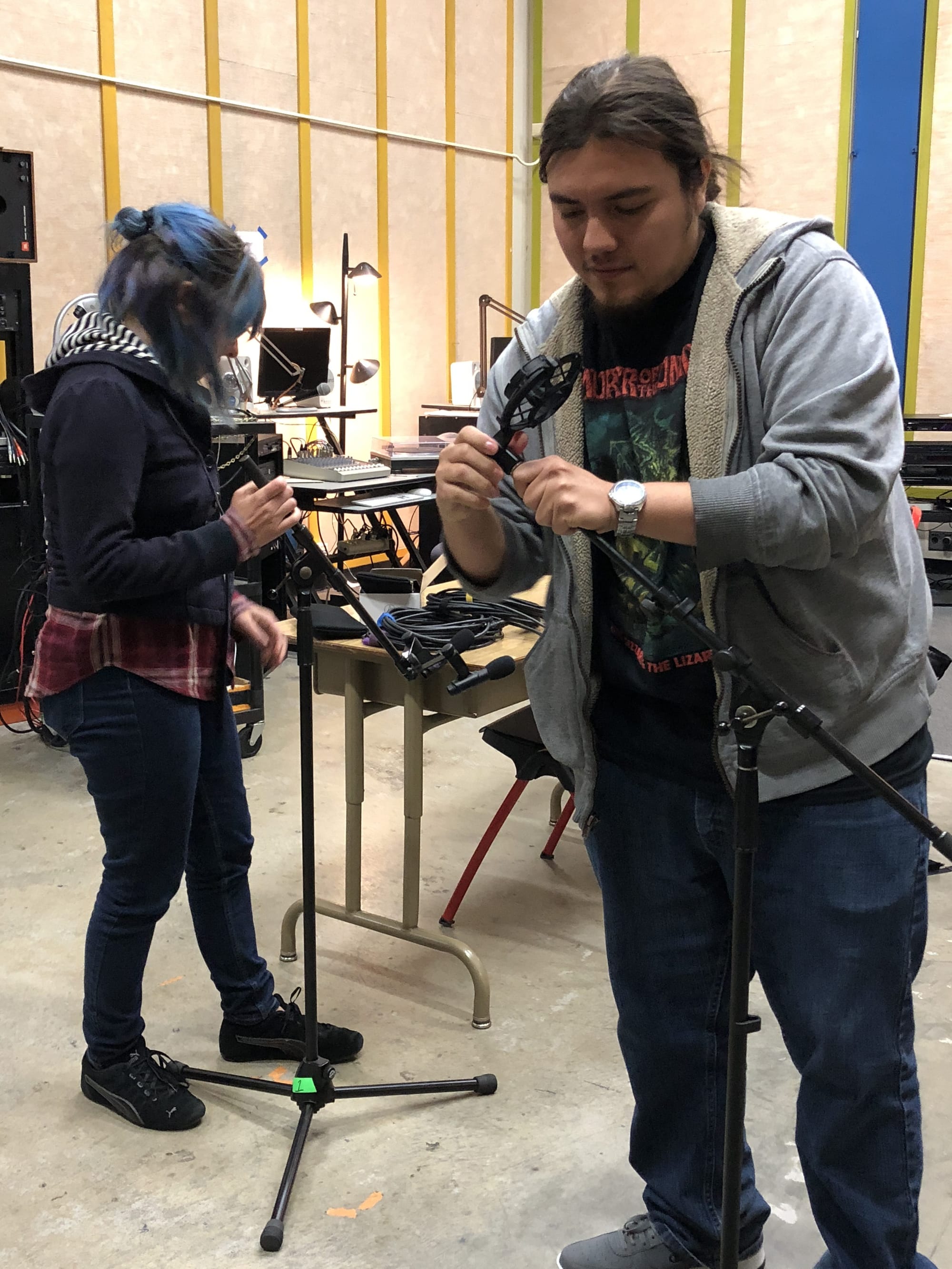 Advanced Studio Recording Students Jorge Villa and Sarah Thompson adjusting mics. Photo by Dana Jae Labrecque.