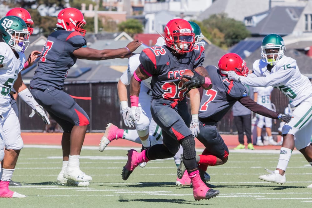 Isaiah Floyd rushes upfield against Diablo Valley College as his teammates help block. Photos by Peter Wong. 