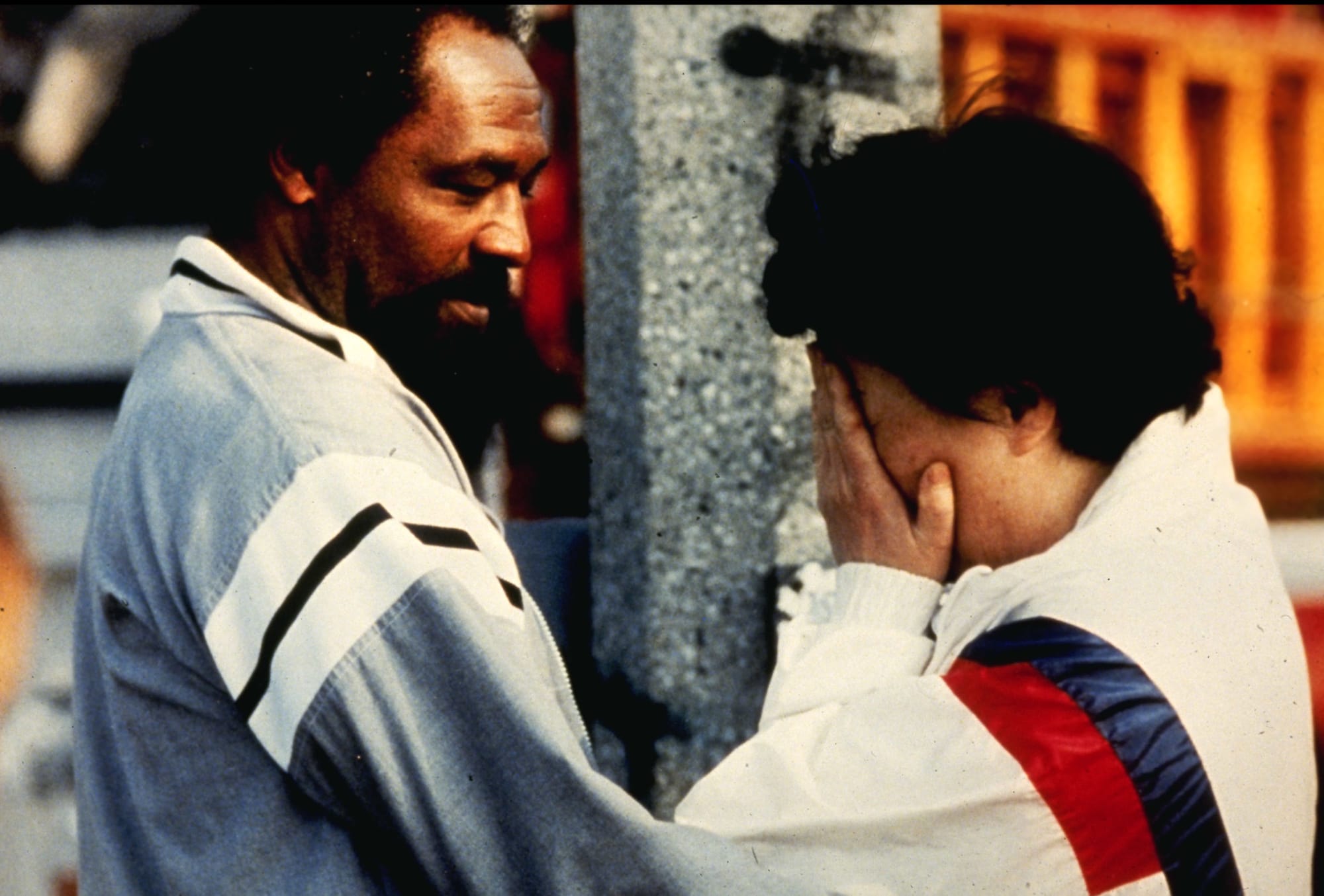 A Korean store owner is comforted by a local resident after she returned to find her place of business looted and burned in south-central Los Angeles, April 30, 1992, during day two of the Los Angeles riots. (Photo by Steve Grayson/WireImage)