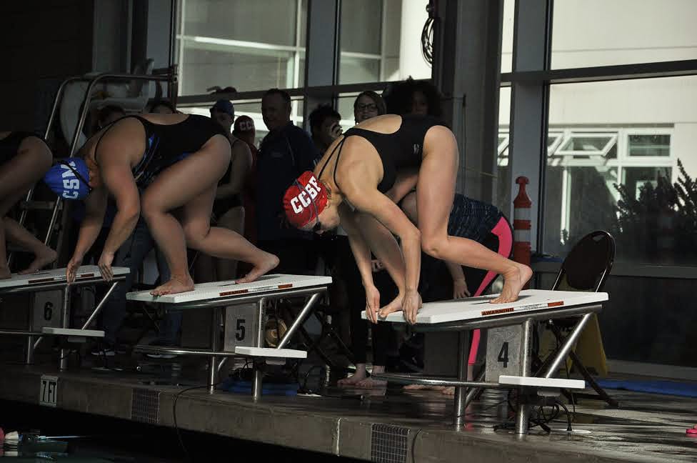 City College women's swimmer Sophia Greco (right) mounts the starting block along side Hana Wong (left) from College of San Mateo seconds before the Women's 500 Yard Freestyle on Feb. 2, 2018. She placed 1st in the heat with a new best time at 5:41.14, shaving more than a second off her previous time. Photo by Peter J. Suter/The Guardsman. 