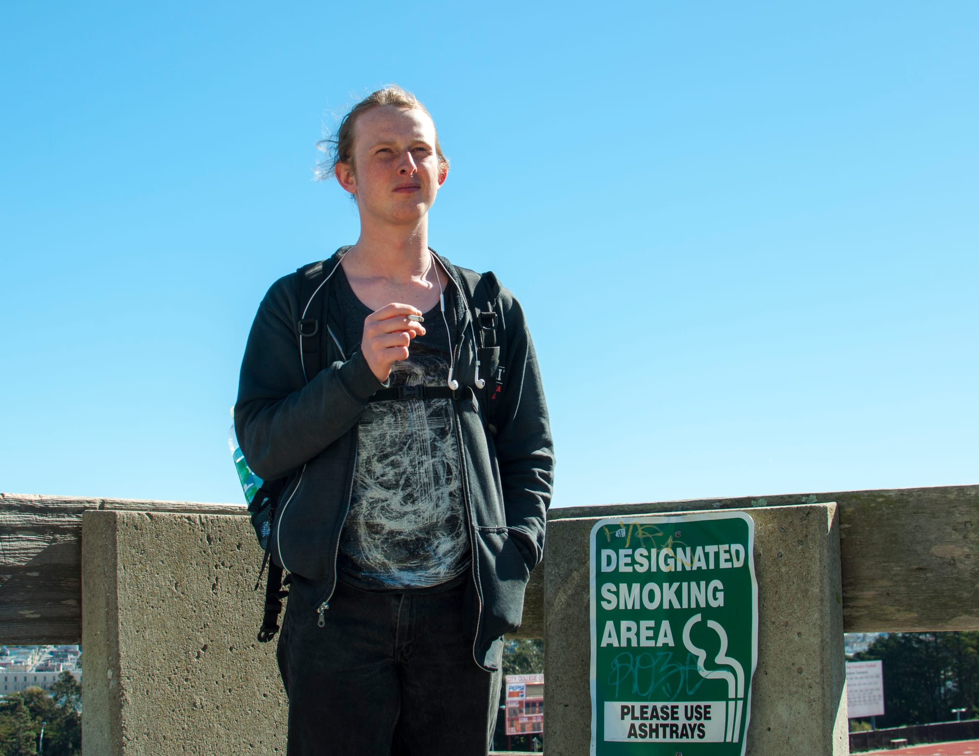 Joseph Howarth, a physics major, takes a smoking break in the designated smoking area outside Batmale Hall on Feb. 15, 2018. Photo by Janeth R. Sanchez/The Guardsman.