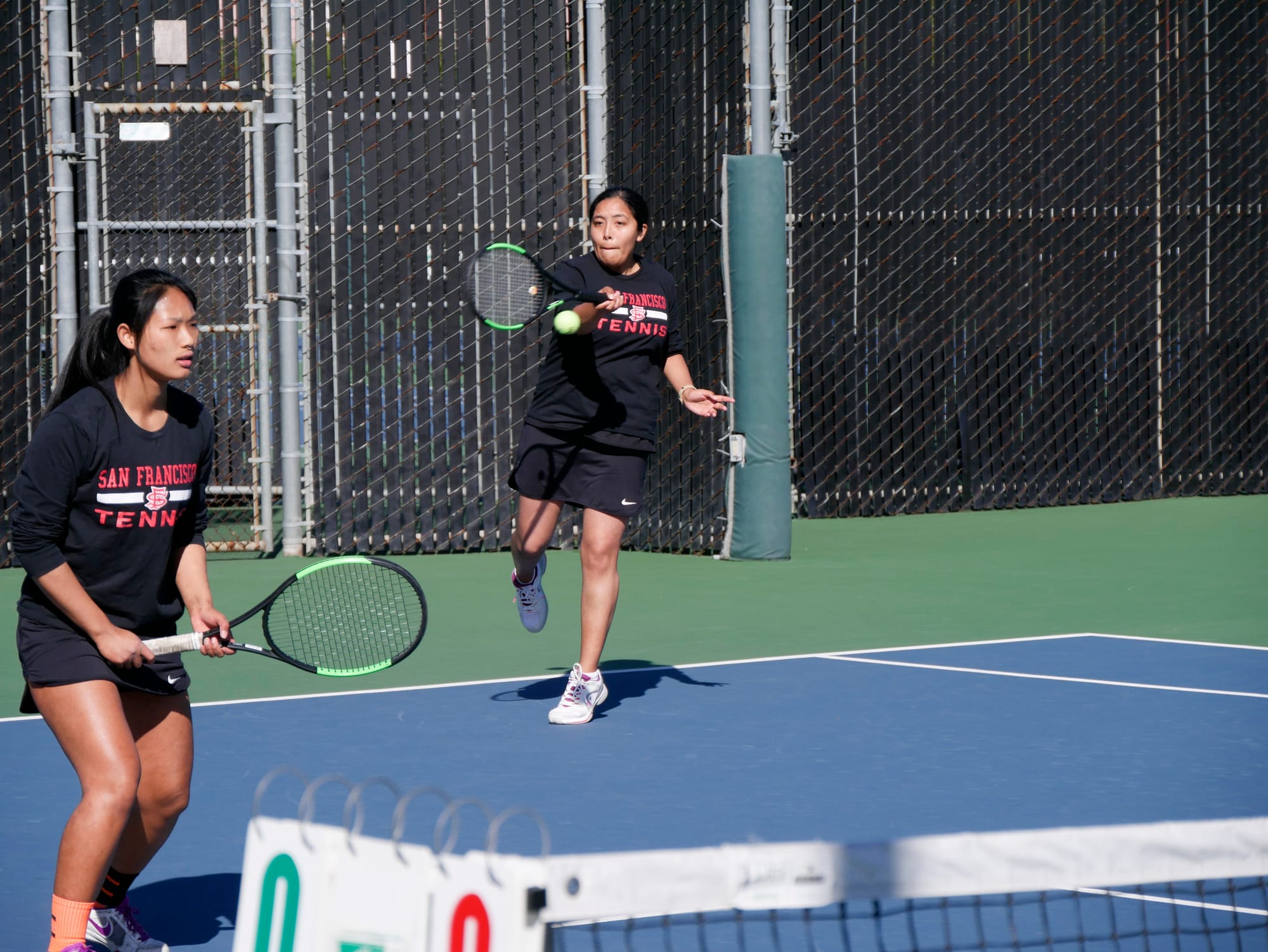 The Rams No. 1 ranked doubles player Abigail Campos (right) returns volley while playing with partner Yvonne Ng (left) in March 2, 2018 match against Mission College. Photo by James Comfort/Special to The Guardsman.