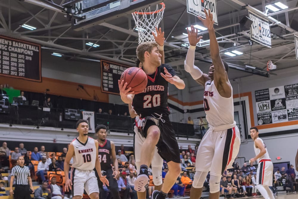 Sophomore guard Curtis Witt (#20) looks for an outlet pass under the basket. Photo by Peter Wong/Special to The Guardsman.