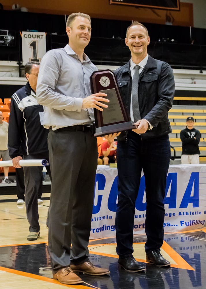 Coach Justin Labagh (left) accepts CCCAA State Title trophy from leagues president Steve Ball after beating San Diego City College in Ventura on March 13, 2018. Photo by Peter Wong/Special to The Guardsman.