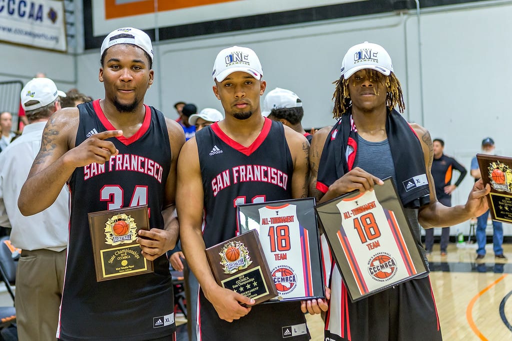 The Rams players sophomore forward Lewis Hayes (#34), left, sophomore guard Eddie Stansberry, center, and sophomore guard Terrell Brown show off their State Title plaques on March 13, 2018. Photo by Peter Wong/Special to The Guardsman.