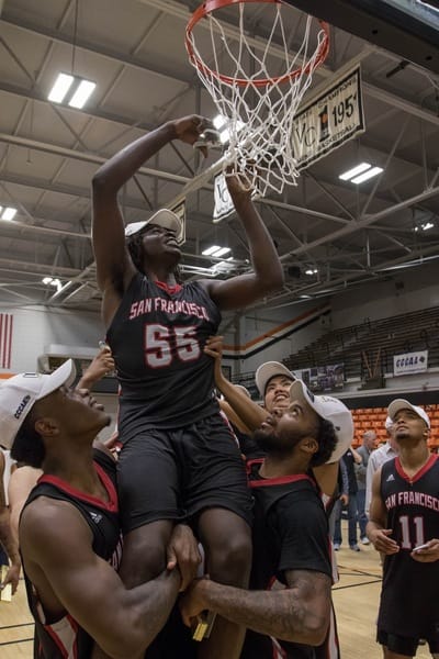 After defeating San Diego City College, the Rams' sophomore guard Michael Wright (#55), forward Lewis Hayes (#34), freshman guard Niamey Harris (#3), sophomore Ben Borja (#24), and Head Coach Justin Labagh are hoisted for the ceremonial cutting of the net on March 13, 2018. Photos by Felix Cortez/Special to The Guardsman.