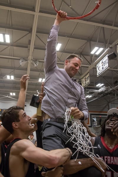 After defeating San Diego City College, the Rams' sophomore guard Michael Wright (#55), forward Lewis Hayes (#34), freshman guard Niamey Harris (#3), sophomore Ben Borja (#24), and Head Coach Justin Labagh are hoisted for the ceremonial cutting of the net on March 13, 2018. Photos by Felix Cortez/Special to The Guardsman.