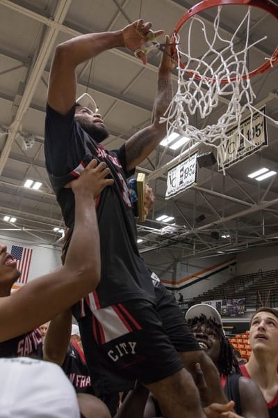 After defeating San Diego City College, the Rams' sophomore guard Michael Wright (#55), forward Lewis Hayes (#34), freshman guard Niamey Harris (#3), sophomore Ben Borja (#24), and Head Coach Justin Labagh are hoisted for the ceremonial cutting of the net on March 13, 2018. Photos by Felix Cortez/Special to The Guardsman.