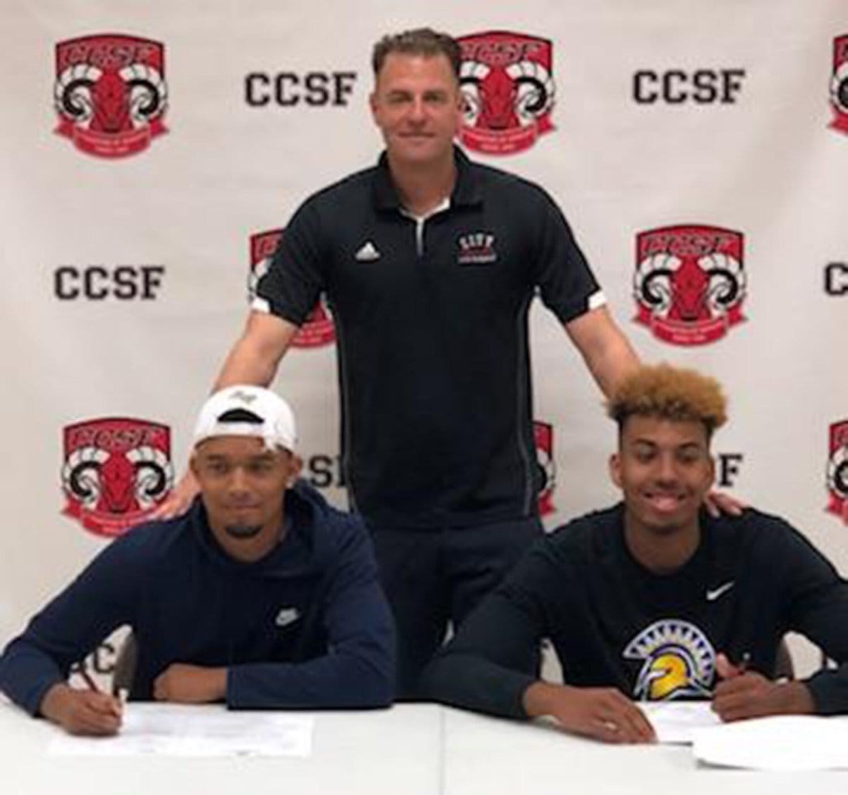 Eddie Stansberry, left to right, Coach Labagh, and Michael Steadman sign to four-year universities on April 16, 2018. Photo courtesy of CCSF Athletic Department.