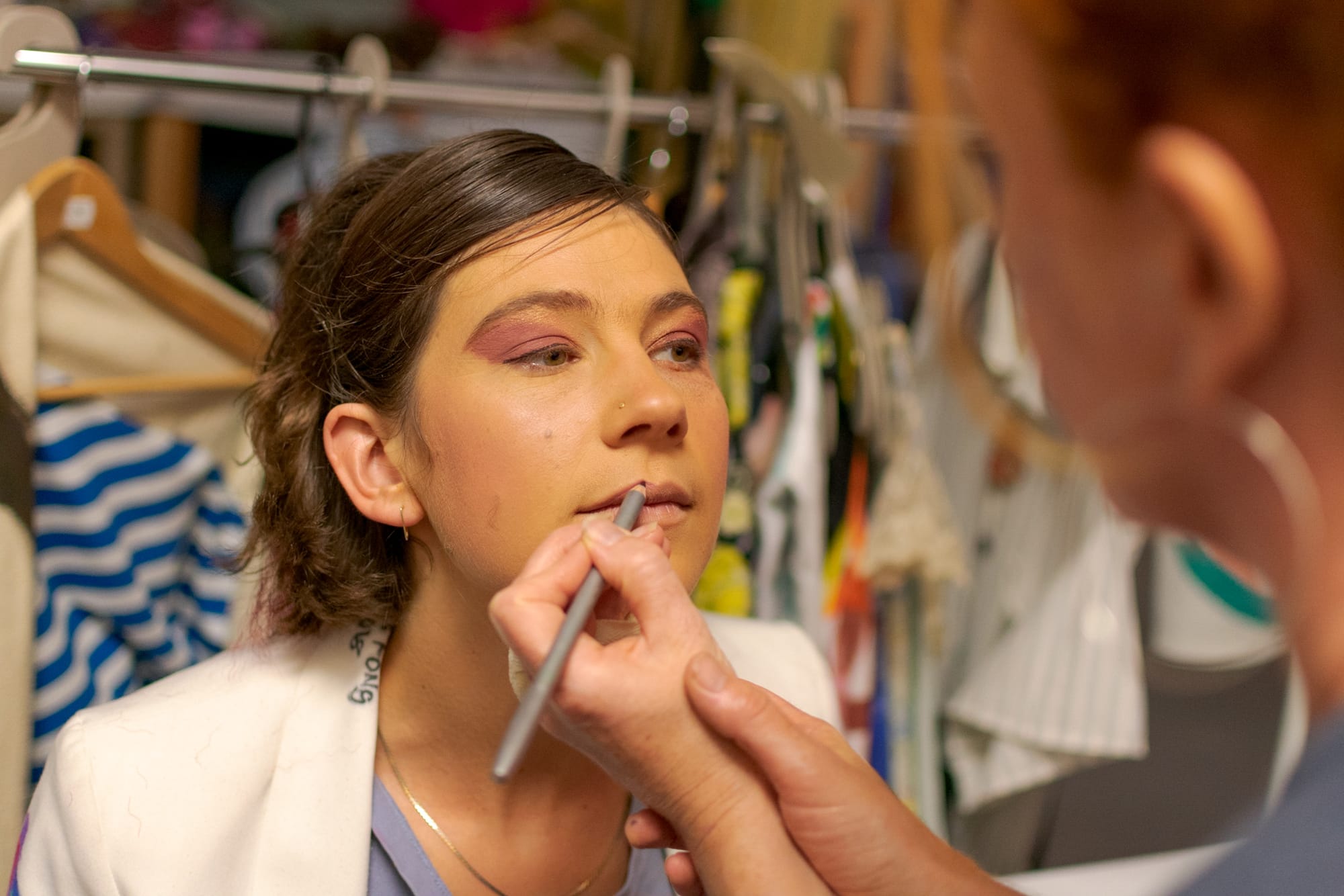 Make-up Artist Andrea Bolding puts lip liner as finishing touches on model Mara Poliak before the Fabulate catwalk begins. Thursday, Sept. 20, 2018. Photo by Cliff Fernandes/The Guardsman